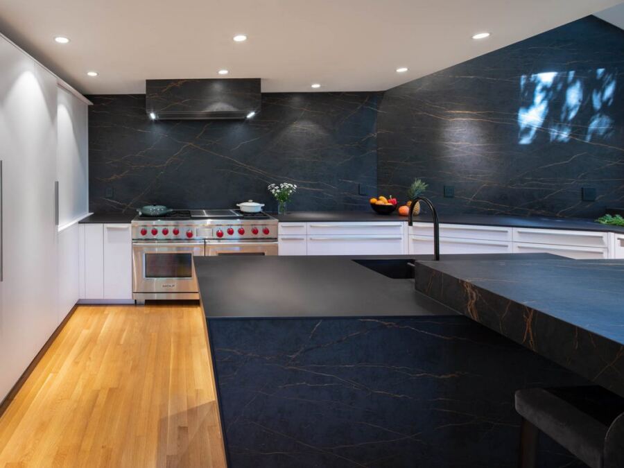 Inalco porcelain island and range wall run in a single matched material, fabricated by Custom Touch Granite