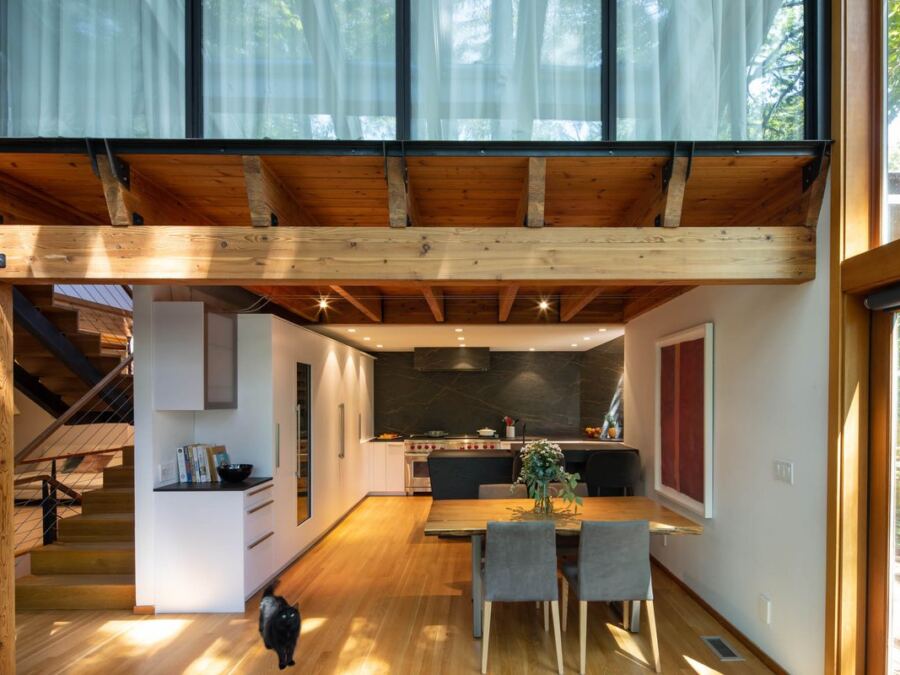 Open-plan kitchen with a full-height Inalco porcelain slab wall and matching island, fabricated by Custom Touch Granite