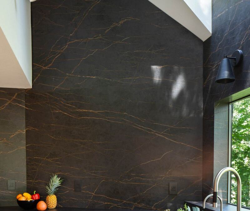 Detail of a full-height Inalco porcelain slab backsplash meeting the countertop, fabricated by Custom Touch Granite