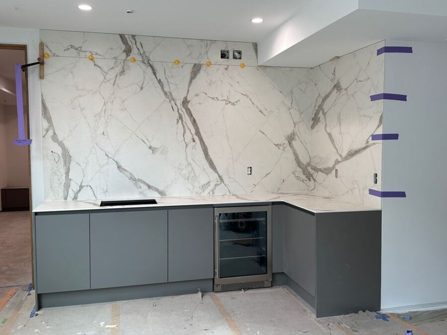 Full-height porcelain slab backsplash above a beverage station