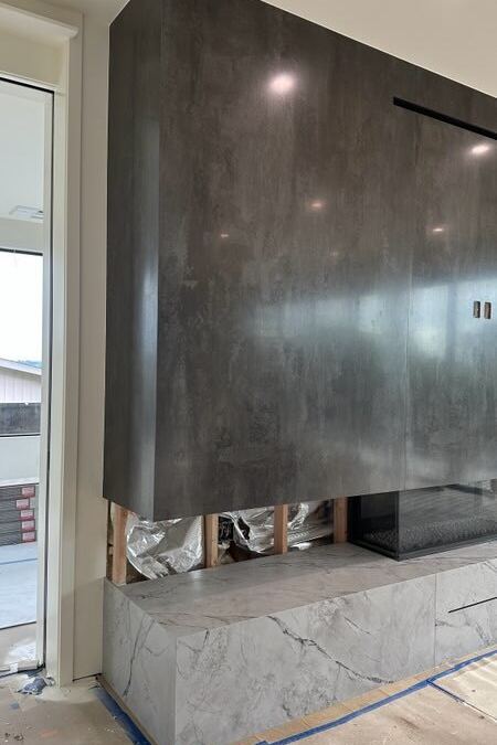 Full-height Neolith porcelain fireplace with mitered sides and marble hearth base, Clyde Hill WA, fabricated by Custom Touch Granite