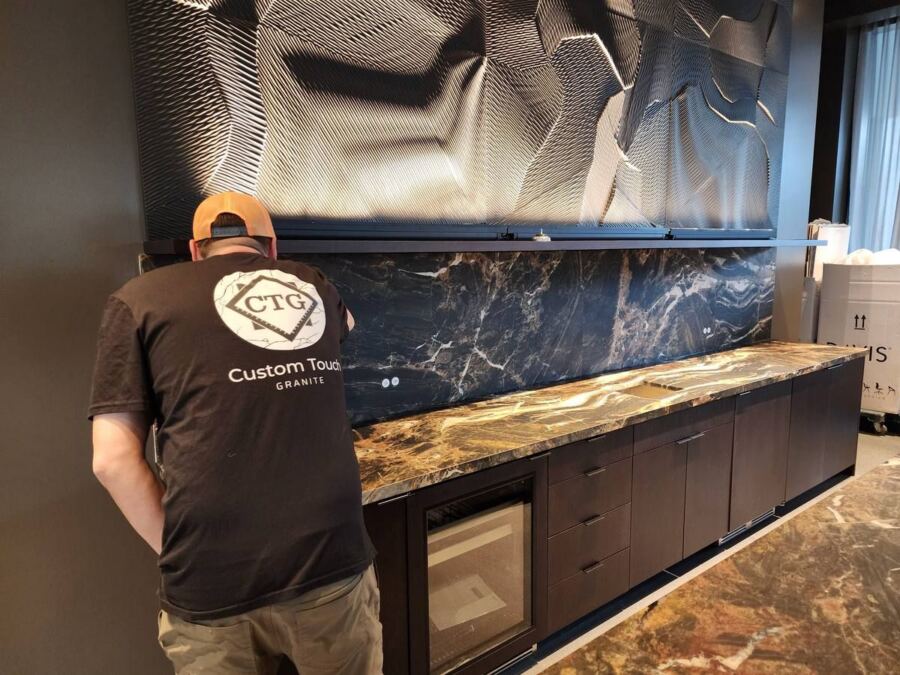 Custom Touch Granite team installing a quartzite backsplash, Downtown Seattle high-rise