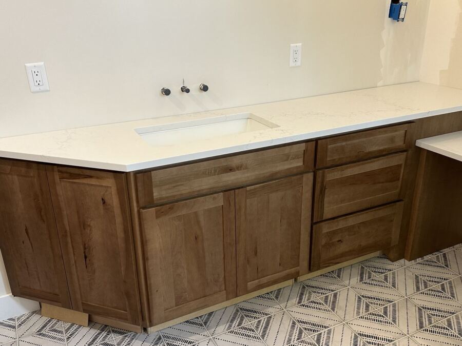 White quartz vanity run with walnut cabinetry