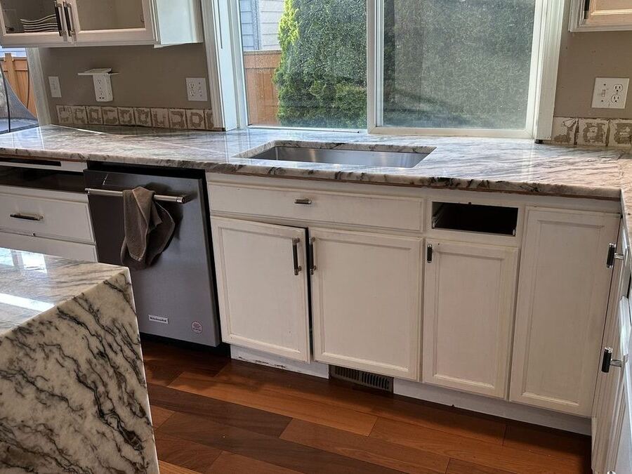 Quartzite kitchen countertops and full-height backsplash by Custom Touch Granite